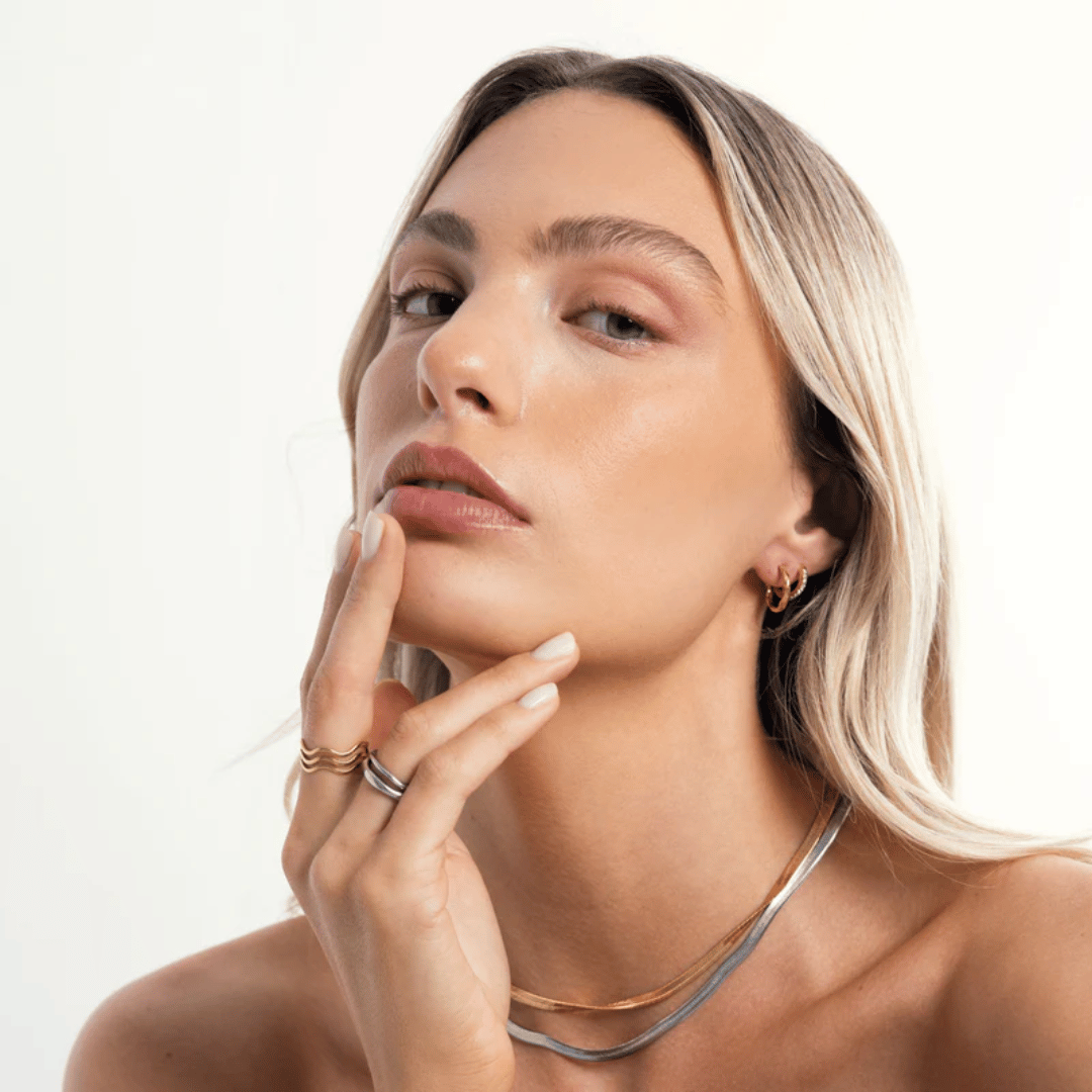 Close-up portrait of woman wearing Moonela Gemini rings – minimalist and bold look