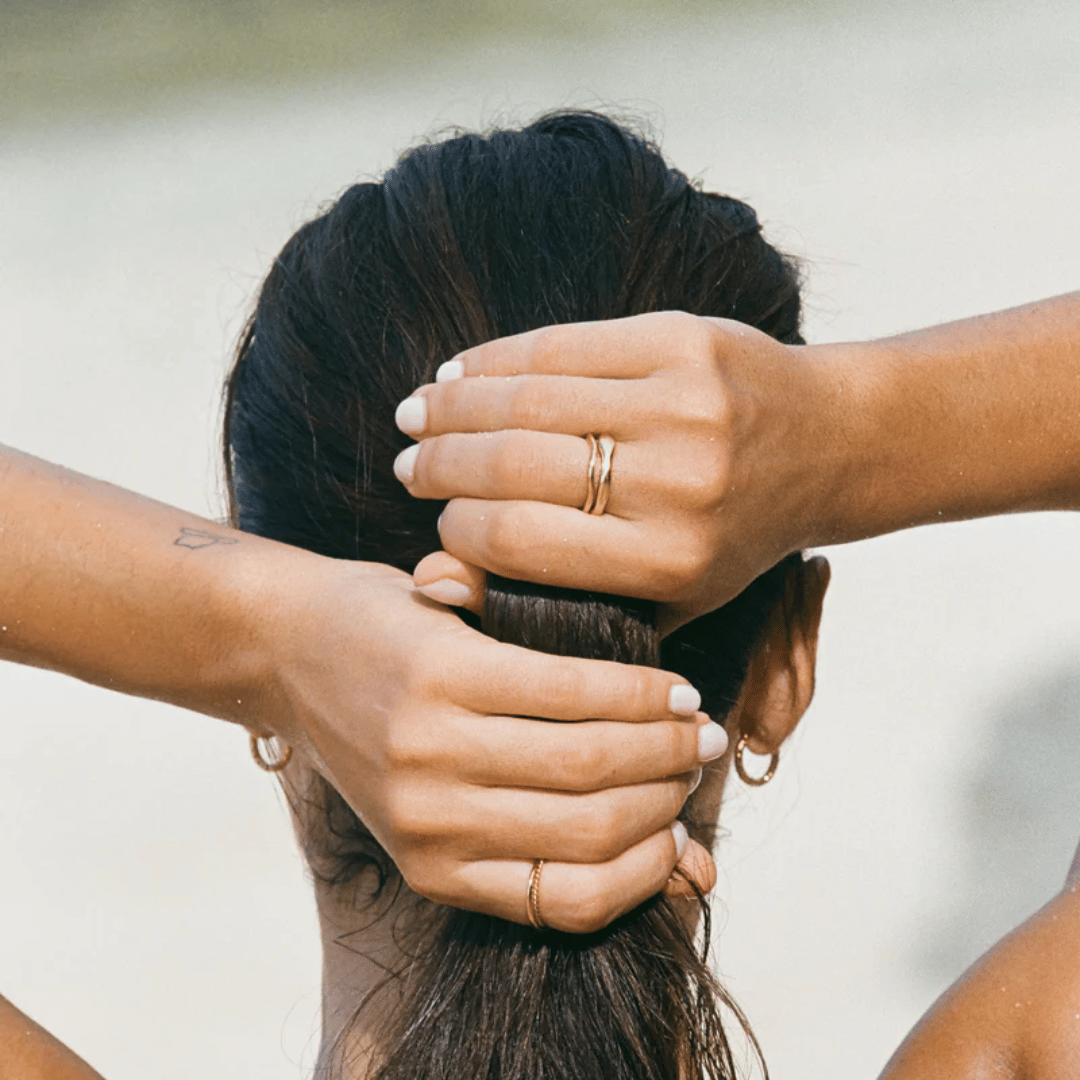 Hands interlaced displaying Moonela Gemini stackable rings – water-resistant daily wear