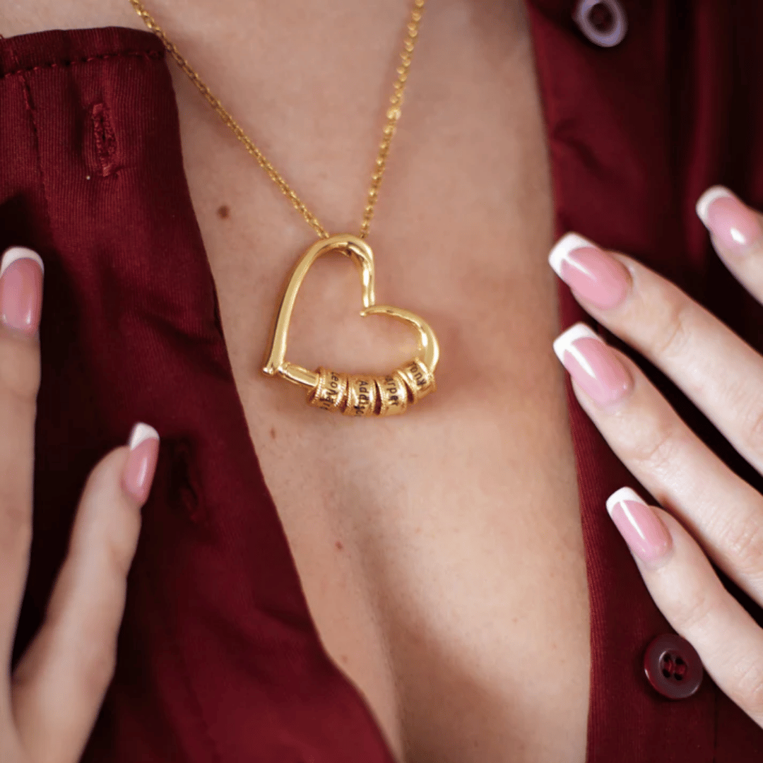 woman holding personalised gold heart necklace